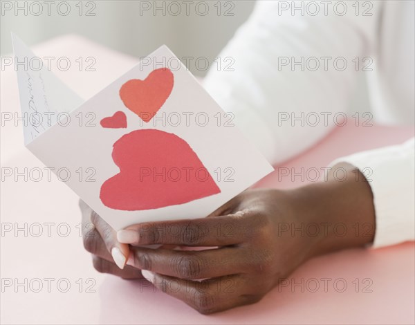 African woman holding Valentine's Day card
