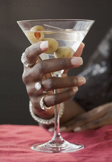 African woman drinking martini