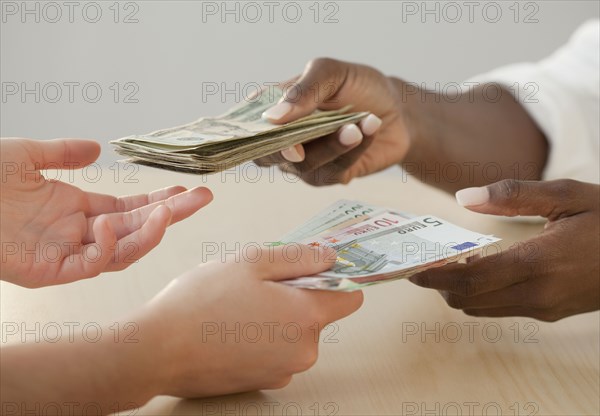 Woman exchanging Euro notes for US currency
