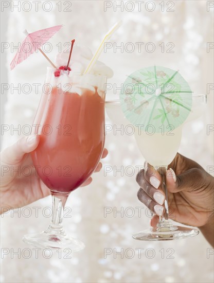 African and Caucasian woman drinking frozen cocktails