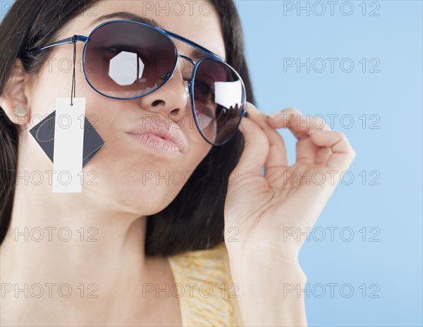 Hispanic woman trying on sunglasses