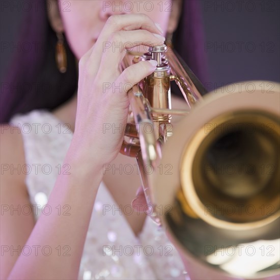 Hispanic woman playing trumpet