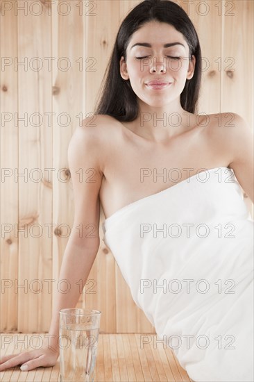 Hispanic woman enjoying sauna