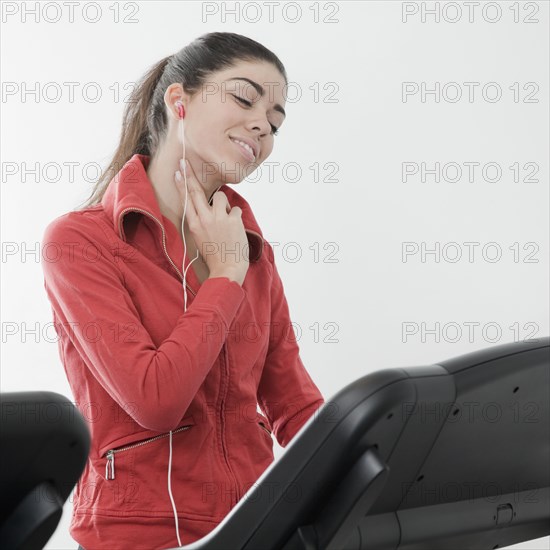 Hispanic woman checking pulse rate in health club