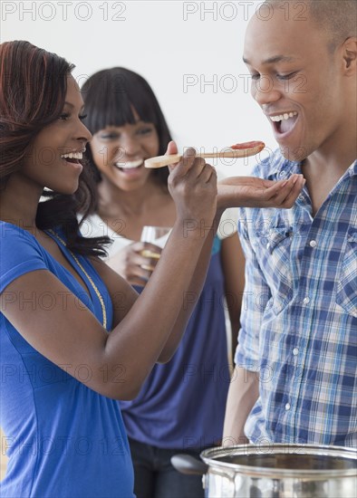 African man tasting tomato sauce