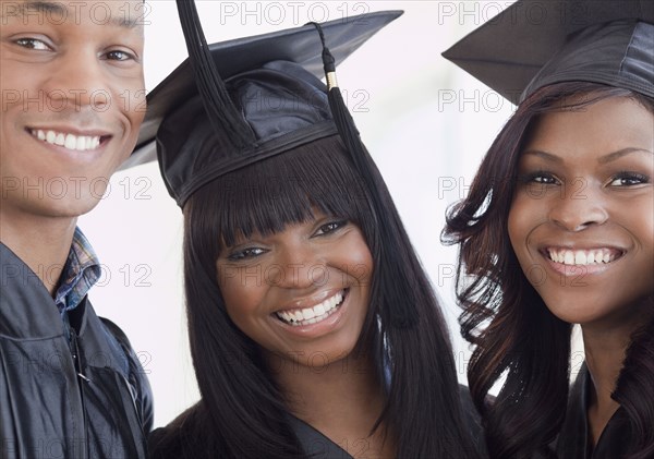 African friends in graduation cap and gown