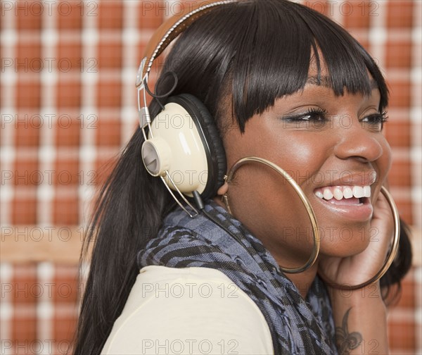 African woman listening to headphones