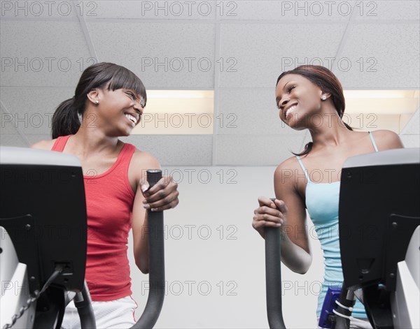 African women using exercise equipment in health club