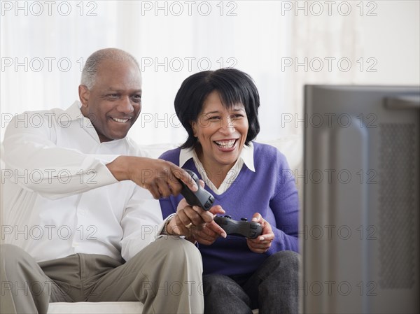 African couple playing video games