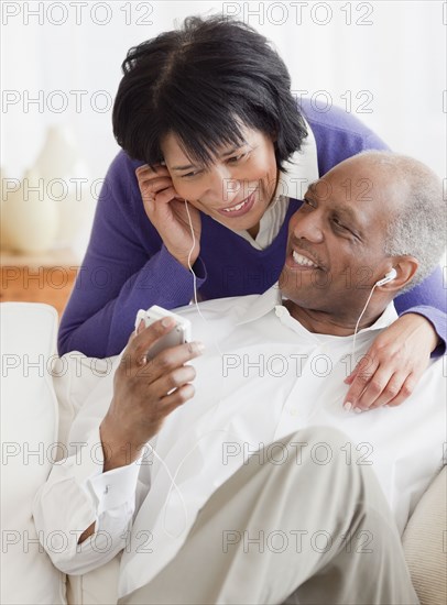 African couple listening to mp3 player