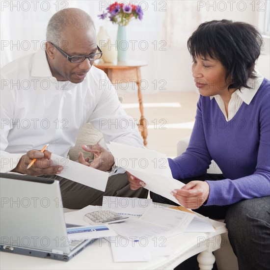 African couple paying bills