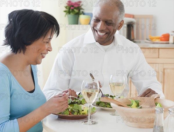 African couple eating salads