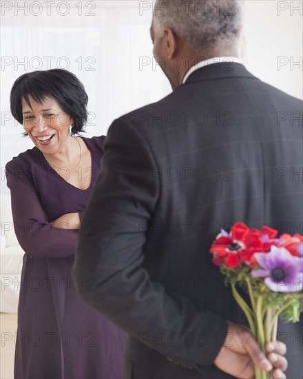 African man bringing wife flowers