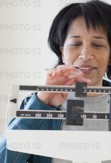 African woman weighing herself