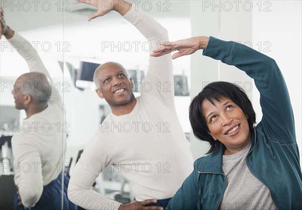 African couple exercising in health club