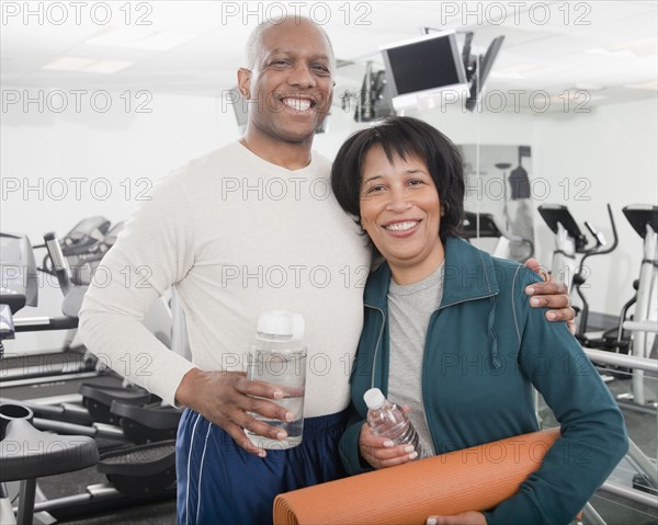 African couple standing in health club