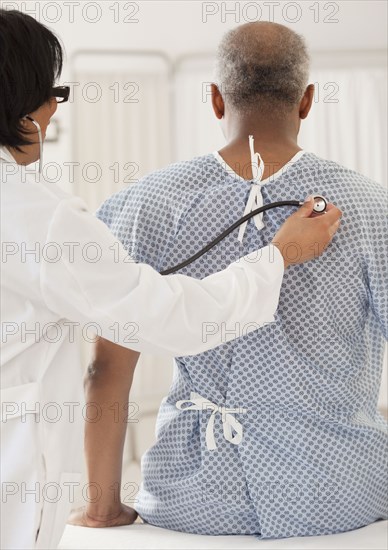 Doctor examining African man