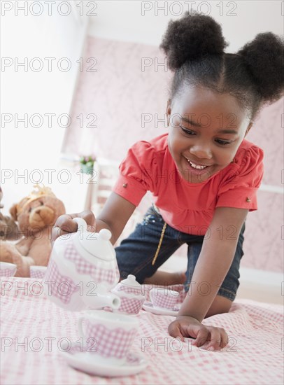 African girl having tea party