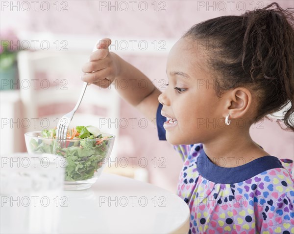 African girl eating salad