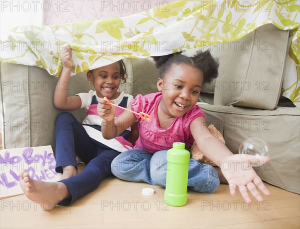 African girls blowing bubbles