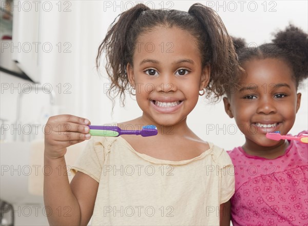 African girls brushing teeth