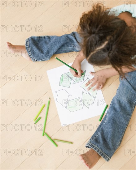 African girl coloring recycling symbol