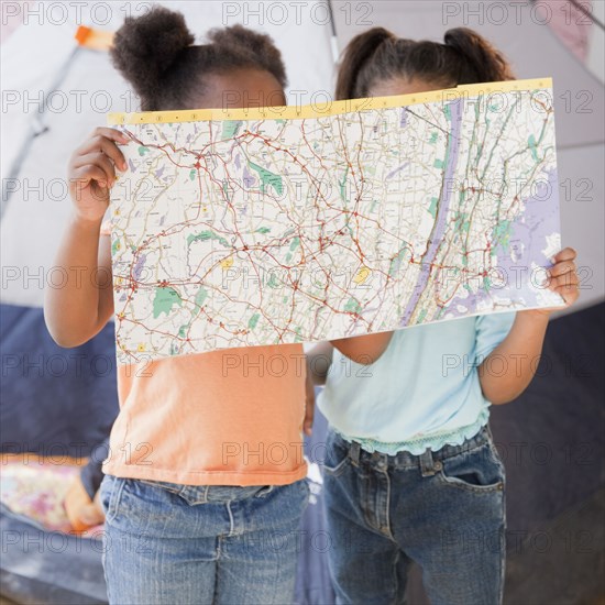 African girls looking at map