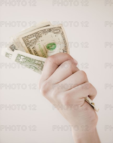 Woman gripping dollar bills
