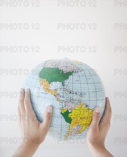 Woman holding inflatable globe