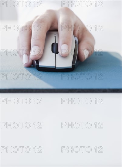 Woman clicking on computer mouse
