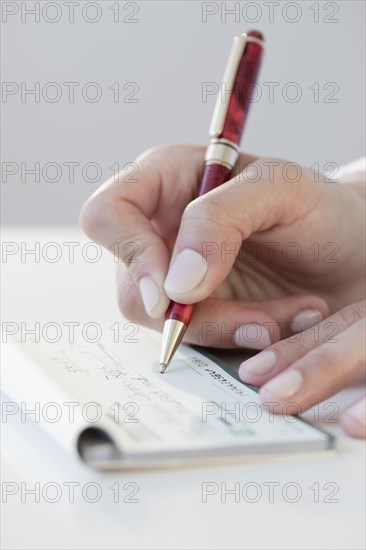 Woman writing personal check