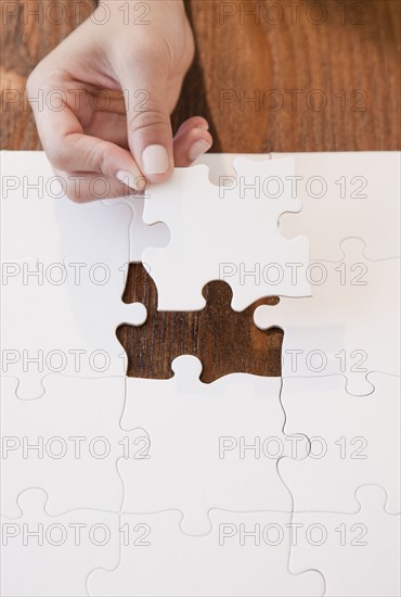 Woman completing jigsaw puzzle