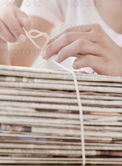 Woman recycling newspapers