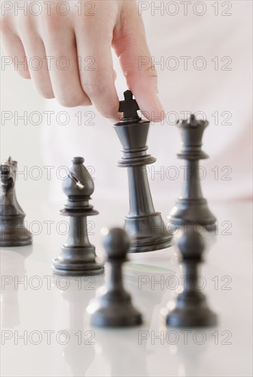 Woman moving chess piece