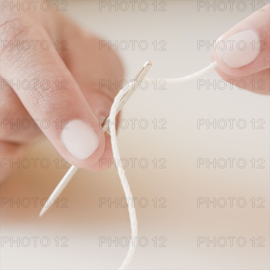 Woman threading needle
