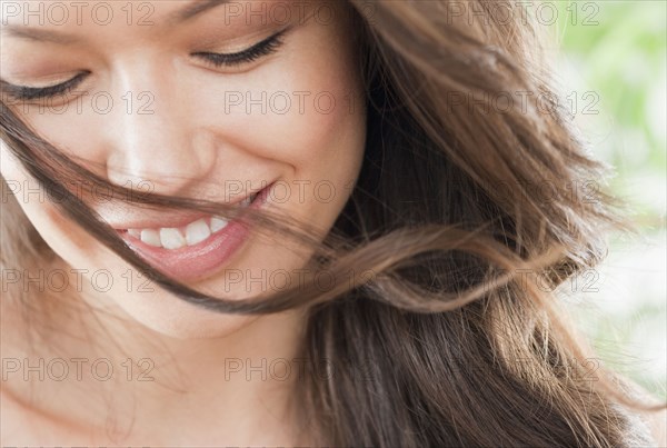 Mixed race woman looking down and smiling