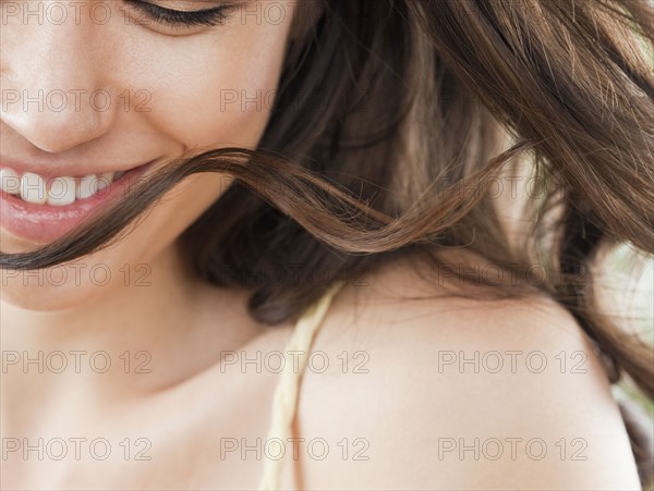 Mixed race woman looking down and smiling