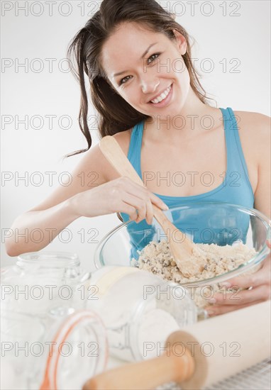 Mixed race woman baking