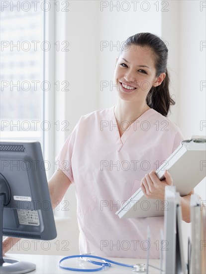 Mixed race nurse at nursing station