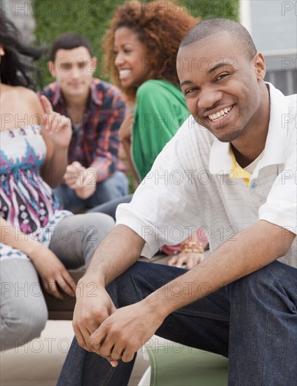 Smiling African man with friends in background