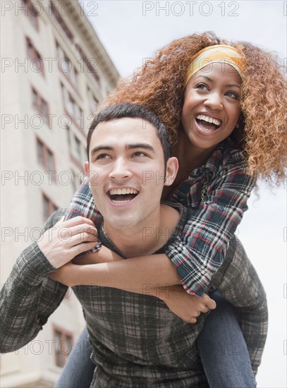 Man piggybacking woman