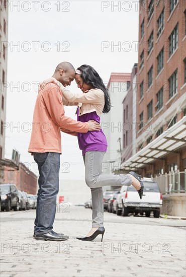 Couple standing face to face on urban street