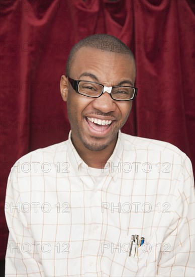 African man wearing taped eyeglasses and making a face