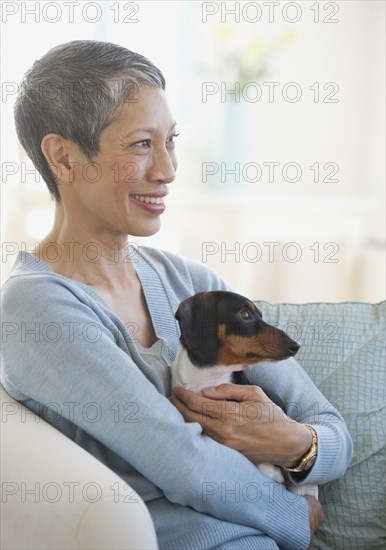 Chinese woman holding dachshund