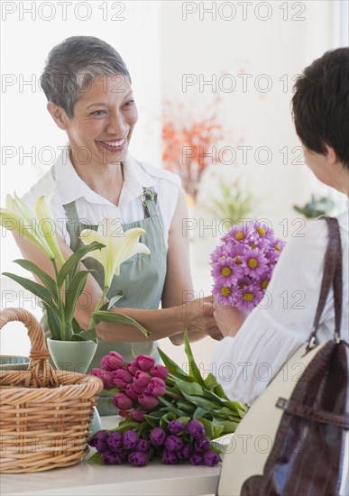 Chinese florist giving flowers to customer