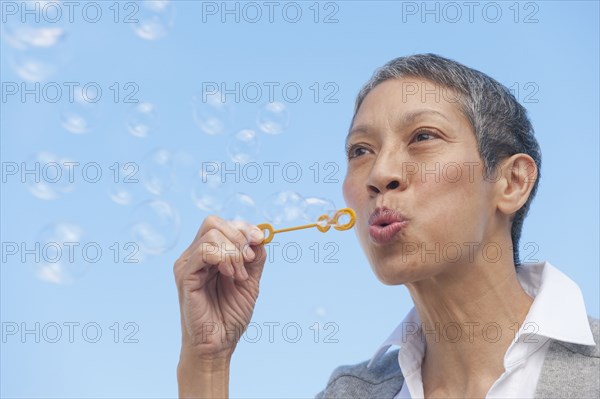 Chinese woman blowing bubbles