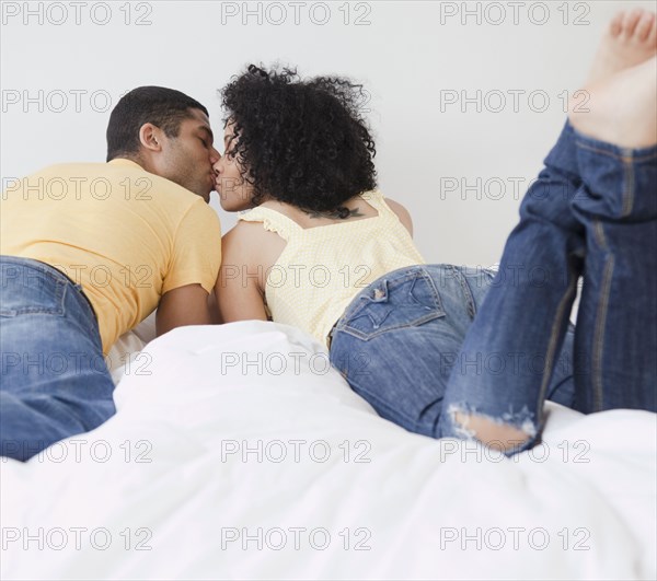 Couple kissing on bed