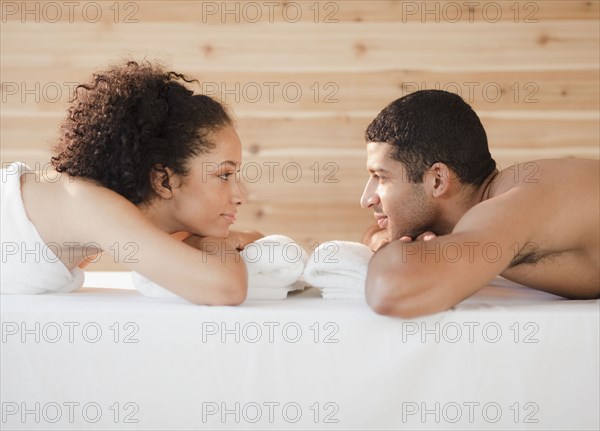 Couple laying face to face on massage table