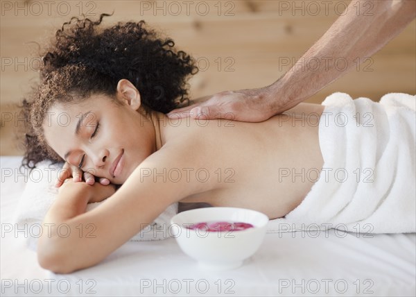 Mixed race woman receiving massage