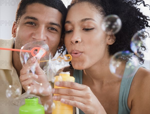 Couple blowing bubbles